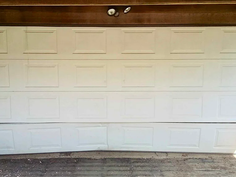 white damaged garage door panel image