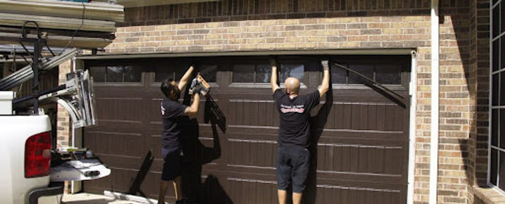 Two worker garage door repair